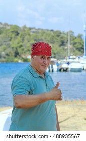 Man In Red Bandana With Raised Thumb Against The Backdrop Of Marina Marmaris