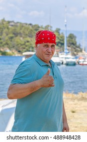 Man In Red Bandana With Raised Thumb Against The Backdrop Of Marina Marmaris