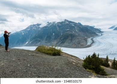 Man In Red Flannel Shirt With Big Glacier In The Background