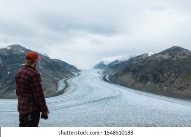 Man In Red Flannel Shirt With Big Glacier In The Background