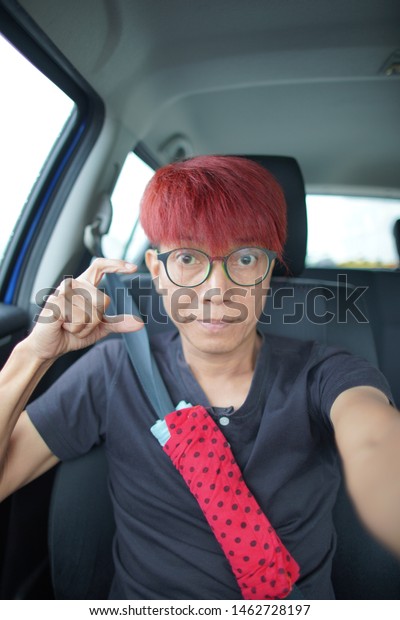 The man with red
hair wear glasses looking hopefully past the camera,The eye of man
in Asia and Glasses accessories personality to look good for all
ages.in-Thailand.
