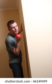 Man With Red Heart Looking Around Corner