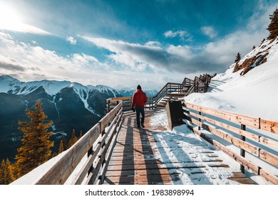 A Man With A Red Jacket Walking On The Path Of Sulfur Mountain In Banff, Canada