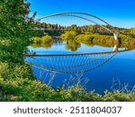 Man in red kayak on the Willamette River rowing under the Peter Courtney Minto Island Bridge in Salem Oregon.