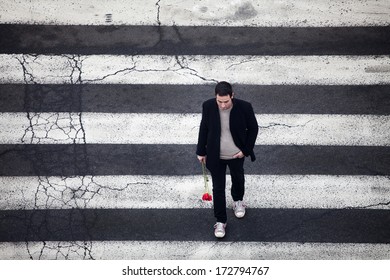 Man with red roses crossing the street - Powered by Shutterstock