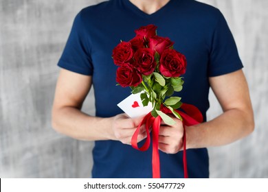 a man with red roses and valentine in the hands. valentine day love beautiful