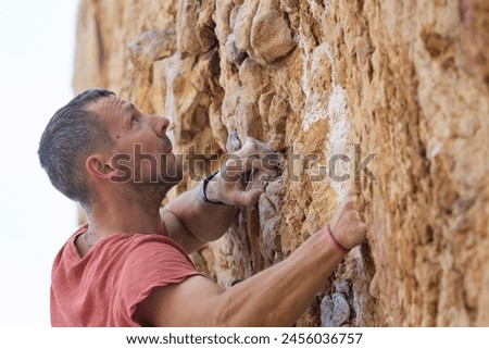 Similar – Little boy looking through the wall of a castle