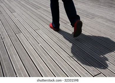 Man with red shoes walking in wooden walk way - Shutterstock ID 32331598
