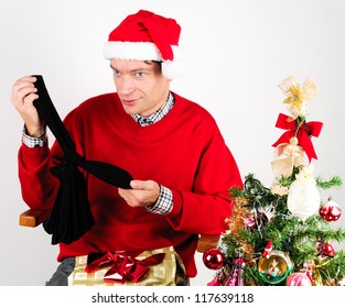 Man In Red Sweater Unwrapping A Christmas Gift