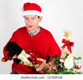 Man In Red Sweater Unwrapping A Christmas Gift