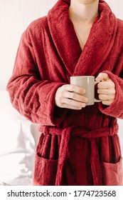 Man In A Red Terry Cloth Robe Holds A Mug. Natural