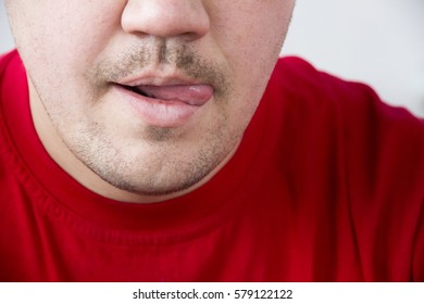 Man In Red T-shirt Licking Lips