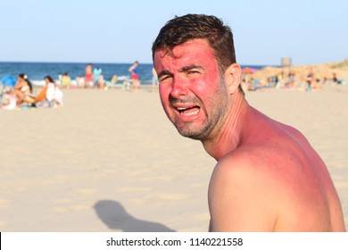 Man with redness crying at the beach