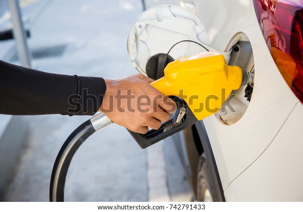 Man Refill and filling\
Oil Gas Fuel at station.Gas station - refueling.To fill the machine\
with fuel. Car fill with gasoline at a gas station. Gas station\
pump. 