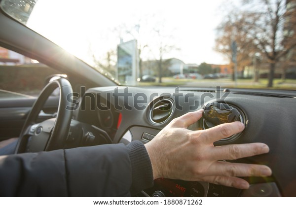 Man refilling car perfume or car scent in the\
interior of car