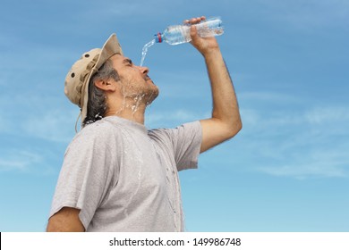 Man refreshing himself with water, outdoor shot. - Powered by Shutterstock