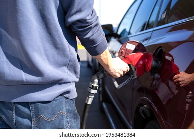 Man Refueling A Big Red Car, Quebec, Canada