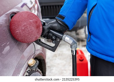 Man Refueling A Big Red Car, Quebec, Canada