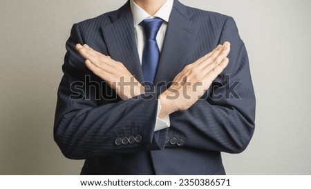 A man in a refusal pose.