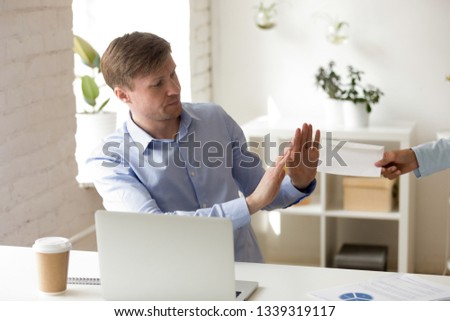 Man refuses to accept bribery envelope. Business corruption concept. Managing position uncorrupted worker offended by illegal money offer in white envelope. Loan acceptance refusal. People at work.