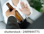 man refuses say no and avoid to drink an alcohol whiskey , stopping hand sign male, alcoholism treatment, alcohol addiction, quit booze, Stop Drinking Alcohol. Refuse Glass liquor, unhealthy, reject