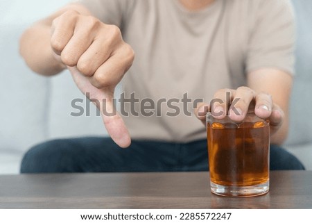 man refuses say no and avoid to drink an alcohol whiskey , stopping hand sign male, alcoholism treatment, alcohol addiction, quit booze, Stop Drinking Alcohol. Refuse Glass liquor, unhealthy, reject
