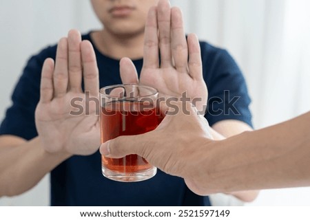 man refuses say no and avoid to drink an alcohol whiskey , stopping hand sign male, alcoholism treatment, alcohol addiction, quit booze, Stop Drinking Alcohol. Refuse Glass liquor, unhealthy, reject