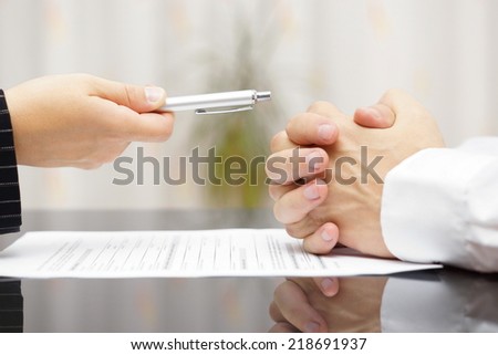 man refusing to sign a document