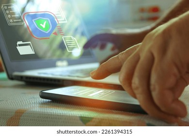 Man registering for computer access security via mobile phone before accessing the computer