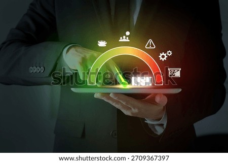 Man regulating level of risk on tablet computer, closeup. Virtual scale and icons