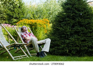 Man Relax Outdoor In His Own Garden At Summer Day