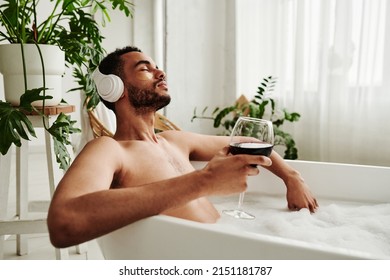 Man Relaxing In Bath With Glass Of Wine