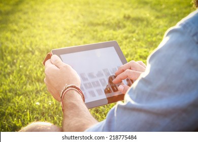 Man Relaxing With Digital Tablet Outdoor