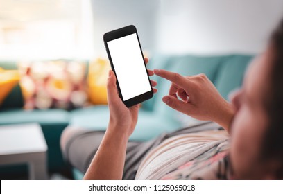 Man relaxing during using smartphone blank screen while lying on sofa - blank screen smartphone