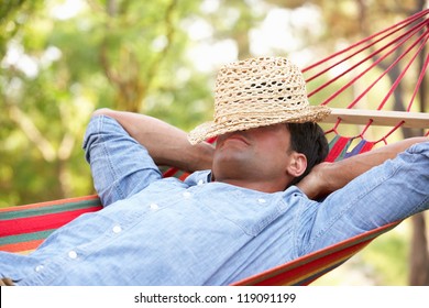 Man Relaxing In Hammock