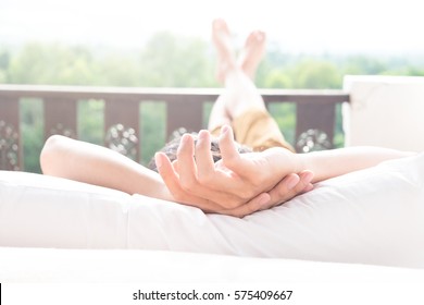 Man Relaxing In His Chair And Enjoying The View From Terrace.