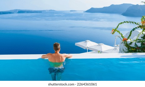 man relaxing in infinity swimming pool during vacation at Santorini, swimming pool looking out over the Caldera ocean of Santorini, Oia Greece, Greek Island Aegean Cyclades luxury vacation. - Powered by Shutterstock - Get 15% off with code: PIKWIZARD15