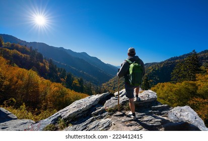 Man relaxing on autumn hiking trip. Man hiker  standing on top of the mountain enjoying beautiful fall scenery. Smoky Mountains National Park, near Gatlinburg, Tennessee, USA - Shutterstock ID 2224412415