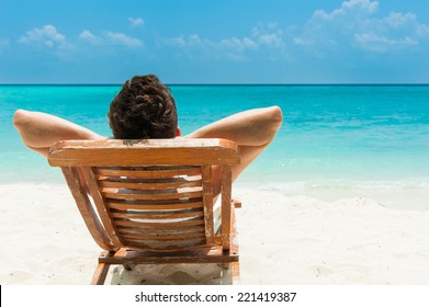 Man relaxing on beach, ocean view, Maldives island