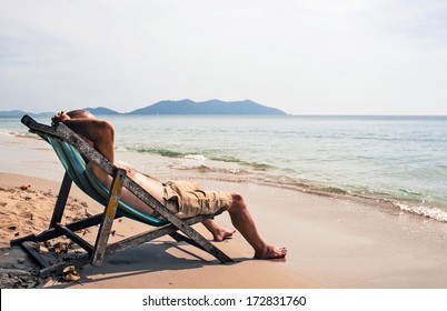 Man Relaxing On Deckchair 