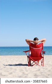 Man Relaxing On Deckchair