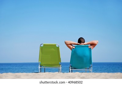 Man Relaxing On Sunbed