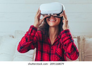 The man relaxing and playing VR goggles and using futuristic tablet  at home. the concept of metaverse, versual reality, future, technology, and internet of things. - Powered by Shutterstock