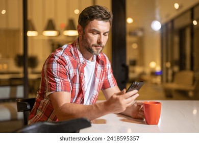 Man relaxing sitting on couch while looking at mobile phone. Mature man using smartphone to checking email at home. Man reading news on smartphone. Man talking on mobile phone. - Powered by Shutterstock