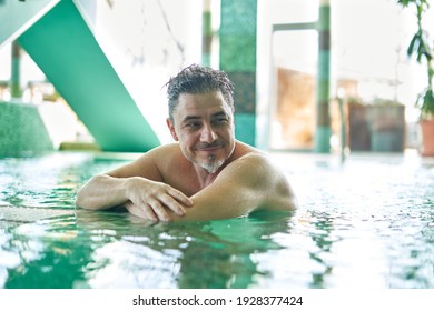 Man relaxing in swimming pool. Concepts of spa, wellness. - Powered by Shutterstock