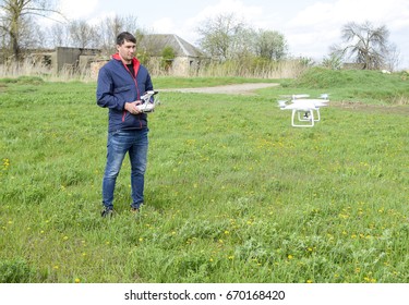 A man with a remote control in his hands. Flight control of the drone. 