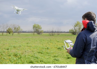 A man with a remote control in his hands. Flight control of the drone. 