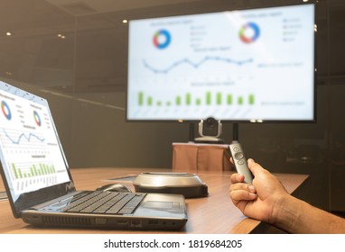 A man with a remote control slide presentation with Presentation meeting on television - Shutterstock ID 1819684205