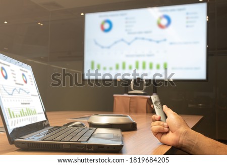 A man with a remote control slide presentation with Presentation meeting on television