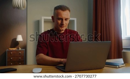 Man remote worker get ready work home. Guy come early morning sit down desk open laptop type keyboard. Male employee surfing net. Busy serious person use pc. Online computer freelancer. Distant job.